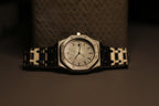 Bartlett 1954 Serov with a white dial on its silver bracelet, front view against a dark background