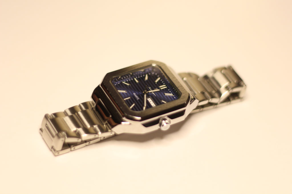 Bartlett 1954 Novella lying on its side, blue lined dial and steel bracelet