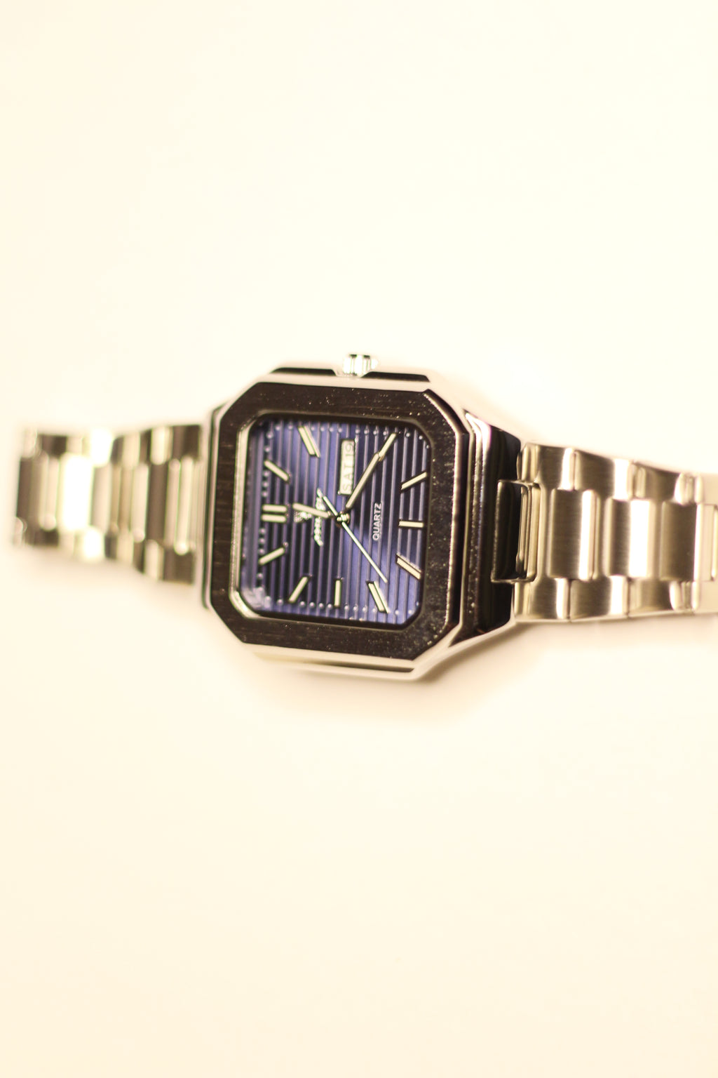 Bartlett 1954 Novella standing upright, square case with a blue lined dial and day-date