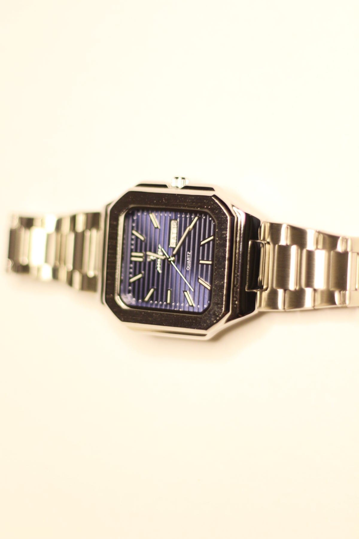Bartlett 1954 Novella standing upright, square case with a blue lined dial and day-date