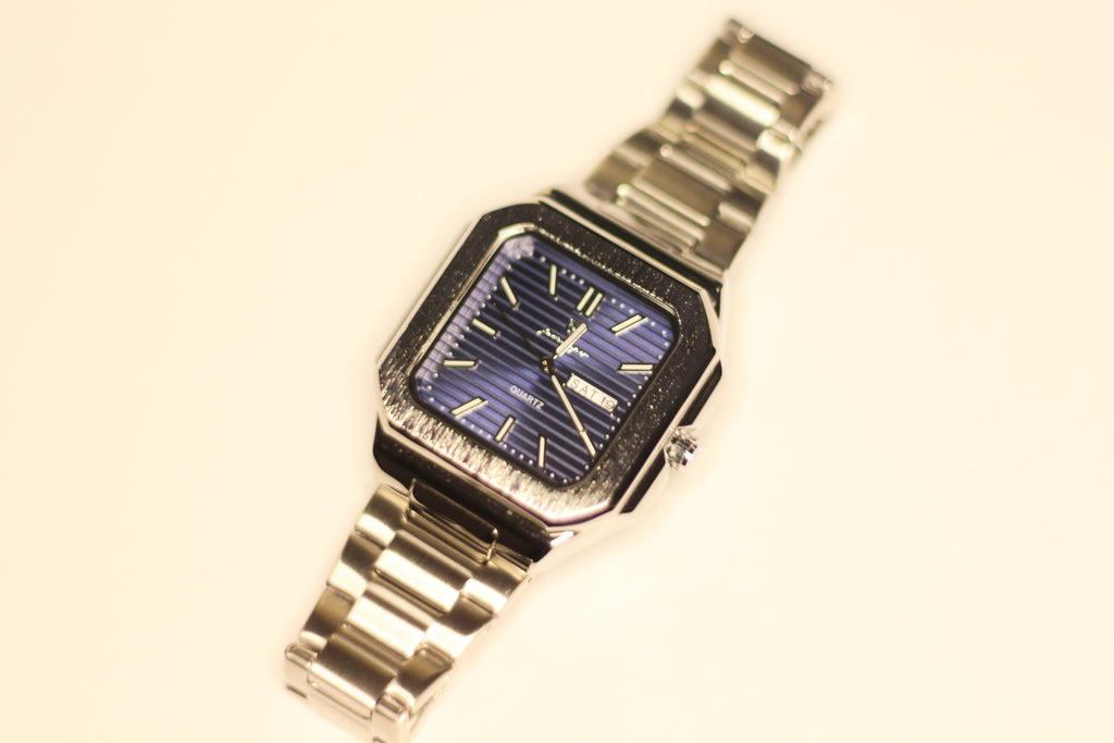 Bartlett 1954 Novella, square stepped case with a blue lined dial on a silver steel bracelet, front view