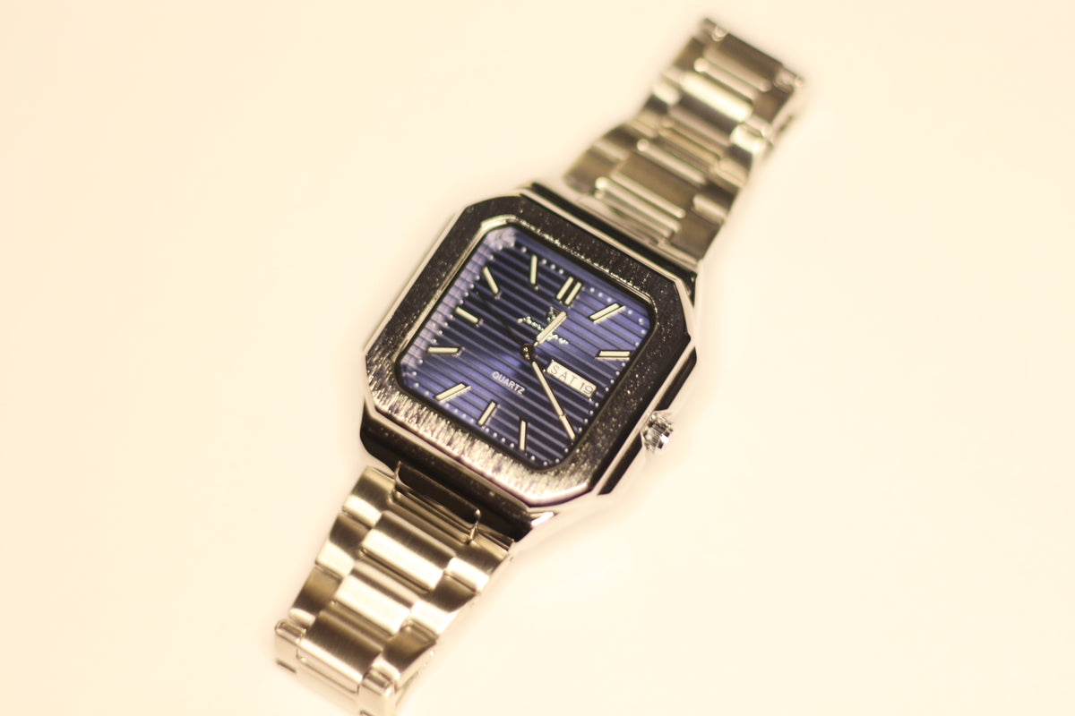 Bartlett 1954 Novella, square stepped case with a blue lined dial on a silver steel bracelet, front view