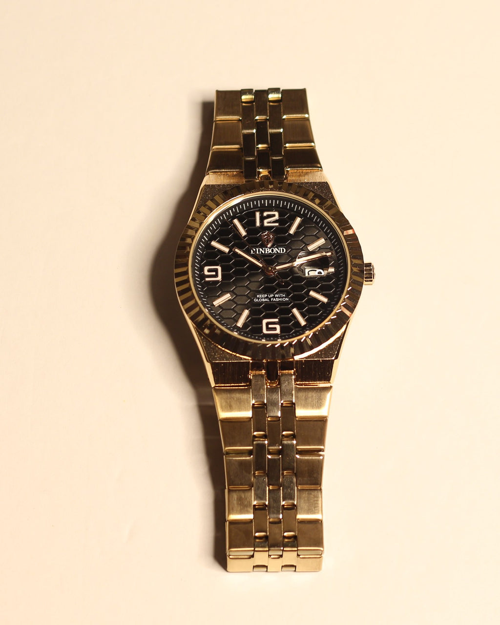 Bartlett 1954 Coralis, rose gold case and bracelet with a black honeycomb dial and fluted bezel, front view