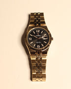 Bartlett 1954 Coralis, rose gold case and bracelet with a black honeycomb dial and fluted bezel, front view