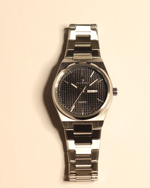Bartlett 1954 Orin, silver steel case and bracelet with a black textured dial, front view