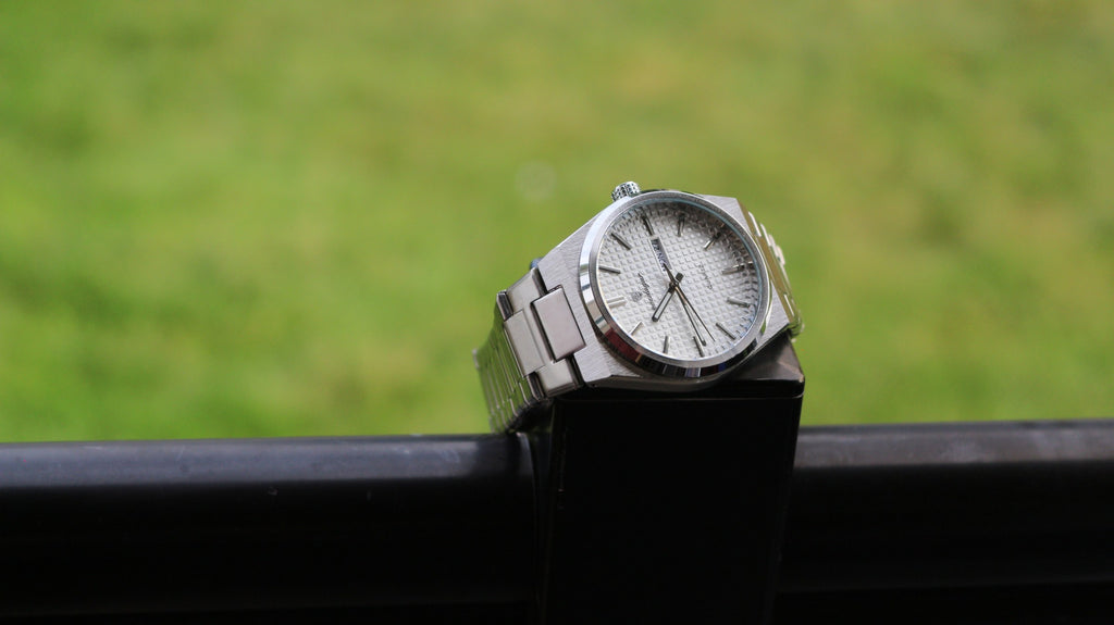 Bartlett 1954 Orin with a white textured dial, angled view outdoors