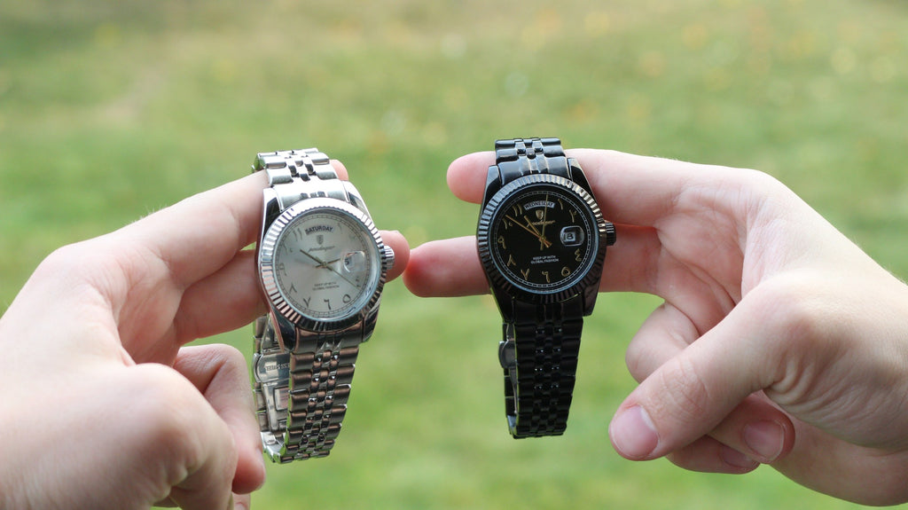 The Emperor in silver and in black held side by side outdoors