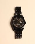 Bartlett 1954 The Emperor, black case and five-link bracelet with a fluted bezel, Arabic numerals and day-date, front view